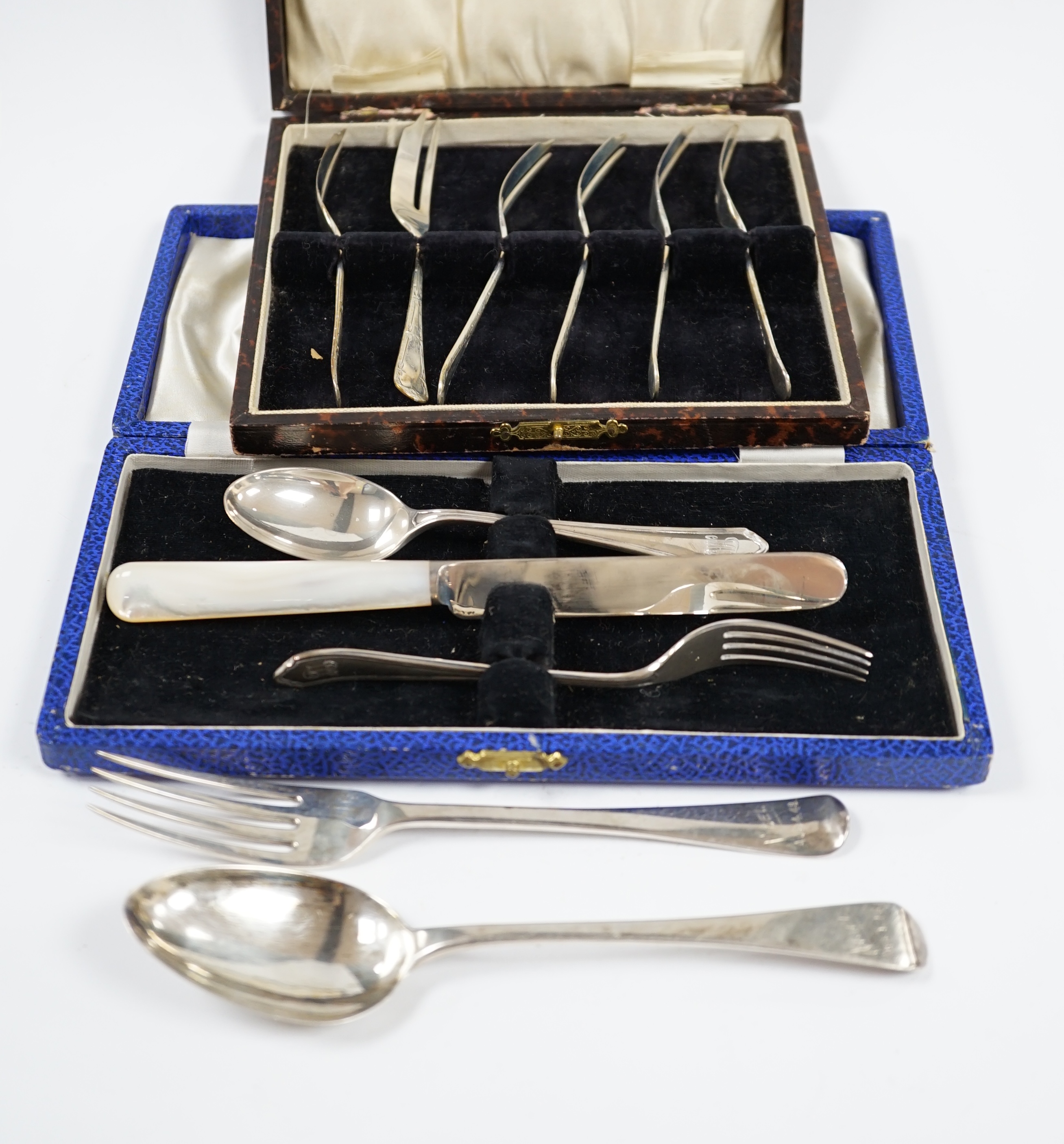 A George VI cased silver christening trio, Sheffield, 1946/7, a matched silver christening pair and a cased set of six silver pastry forks. Condition - fair to good